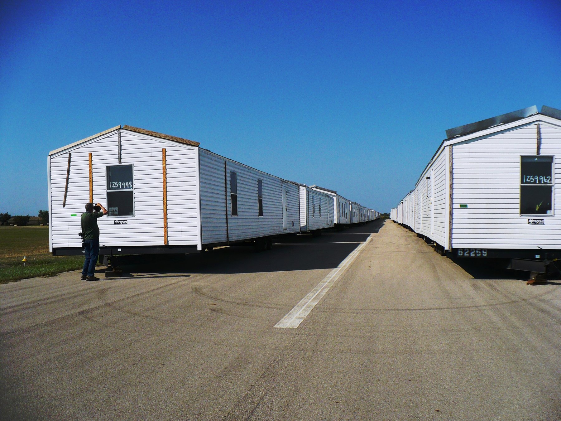 Rows of manufactured homes on their chassis staged for delivery